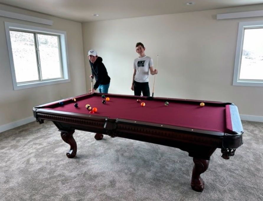 teens playing with a Fairhope billiard table